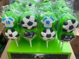green and black soccer themed lollipops on display in a box