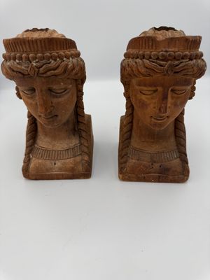 pair of carved wooden head sculptures of a woman and a man
