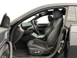 the interior of a car with the door open and the driver ' s seat down