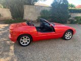 an image of a red sports car parked in a parking lot