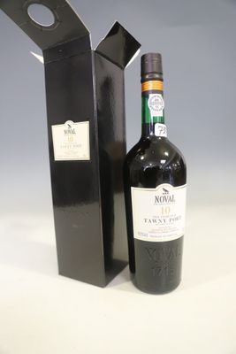 a bottle of wine that is next to a black box