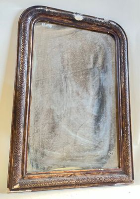 a mirror hanging on the wall above a shelf