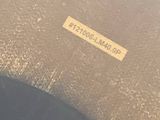 a black suitcase sitting on the ground next to a yellow sticker