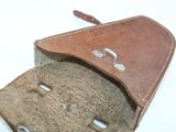 a leather case that is open on a white surface