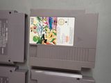 three nintendo game cartridges sitting on top of each other