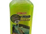 the bottle of liquid is green and has a black cap
