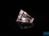 a pink diamond on a black background