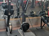 a man that is sitting on a bench in a gym