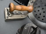 a close up of a metal object with a wooden handle