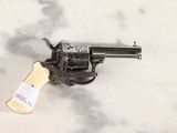 a gun that is on the ground with a tag on it