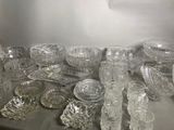 a lot of glass dishes and bowls on the table