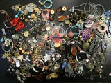 a black table with a bunch of jewelry on it