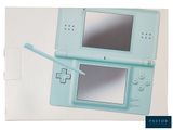 a blue nintendo wii game console with a pen on it