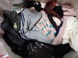a pile of clothes in a suitcase on the floor