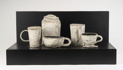black and white photograph of a group of coffee cups and mugs