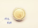 a gold coin sitting on top of a piece of paper