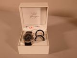 a watch and bracelet in a white box on a table