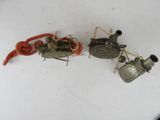 three small metal objects sitting on a white surface
