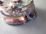 a silver teapot with a lid on a table