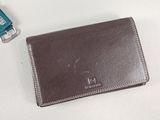 a wallet and a usb drive on a white surface