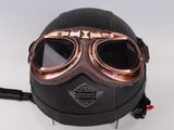 a helmet with goggles attached to it on a white surface
