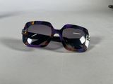 purple and black sunglasses on a table with a white background