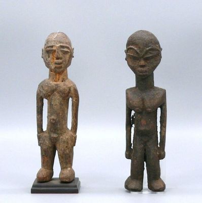 two figurines of a man and a woman standing next to each other