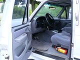 a white truck with its door open in a parking lot
