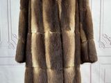 a close up of a fur coat on a mannequin stand