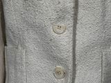 a close up of a woman ' s jacket with buttons