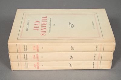 three books are stacked on top of each other on a table