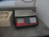 an image of a scale with a box of doughnuts on it