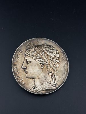 a close up of a coin on a black surface