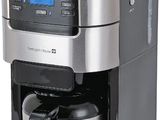 the coffee maker is sitting on a white surface