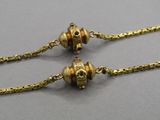 gold plated necklace with two small beads on a chain