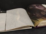 an open book with a picture of a man on it sitting on a table