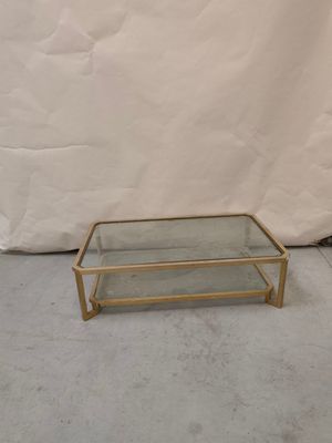 brass and glass coffee table with a glass top