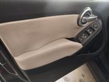 the interior of a car with the door open showing the steering wheel and dashboard