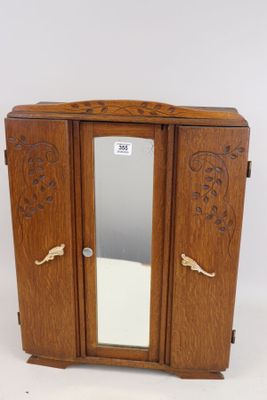 a small wooden cabinet with a mirror on top of it