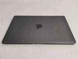 a black apple laptop sitting on a white surface