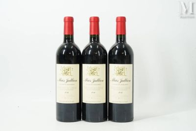 three bottles of red wine sitting next to each other on a table