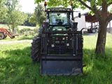 a tractor that is parked in the grass
