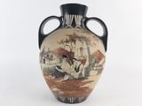 a vase with a picture of a man and a woman on it