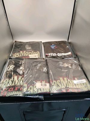 a black box full of t - shirts that are sitting on top of each other