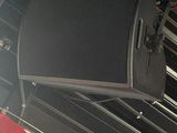 a speaker that is hanging from the ceiling of a room
