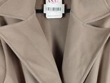 an image of a coat hanging on a hanger on a wall