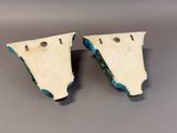 two pieces of white pottery with blue and green designs on them