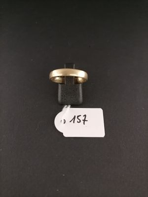 a close up of a ring on a black surface with a price tag