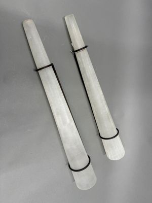 pair of white marble candles with black wire wrapped around them