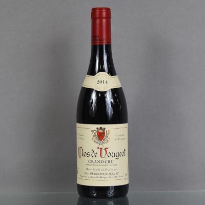 an old bottle of wine sitting on top of a glass table